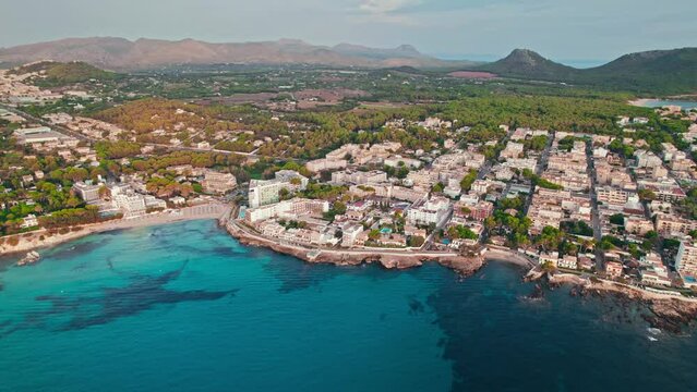 Beautiful landscape beach on Majorca Island in Spain with Hotels and Resorts. Cala Son Moll Beach - early morning drone view from above of the Spanish East Coastline Balearic Islands.