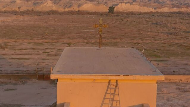 
Old metal cross on top of abandoned structure in desert sunset, aerial

Aerial view over Qasr al-Yahud or The land of the monasteries, israel,2022

