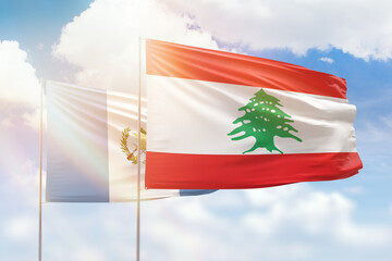 Sunny blue sky and flags of lebanon and guatemala