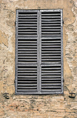 Very old weathered grey window shutters