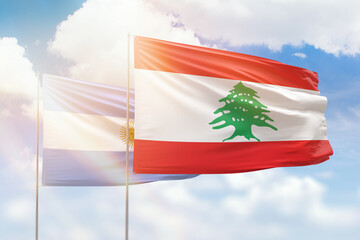 Sunny blue sky and flags of lebanon and argentina