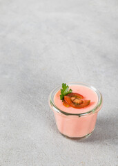 Tomato cream pudding, Panna Cotta in a glass. Light gray background. Copy space