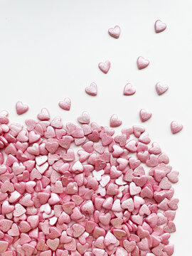 textured background, lots of small decorative candy pink hearts.