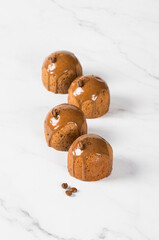 Coffee cakes with chocolate icing.  Light background