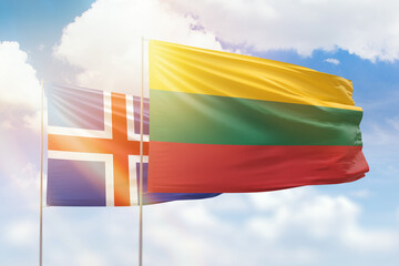 Sunny blue sky and flags of lithuania and iceland