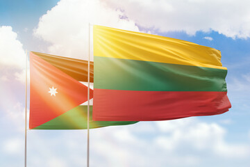 Sunny blue sky and flags of lithuania and jordan