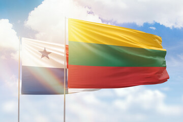 Sunny blue sky and flags of lithuania and panama