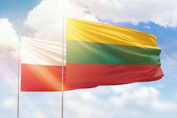 Sunny blue sky and flags of lithuania and poland
