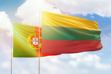 Sunny blue sky and flags of lithuania and portugal