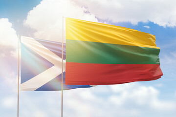 Sunny blue sky and flags of lithuania and scotland