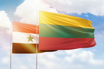 Sunny blue sky and flags of lithuania and syria