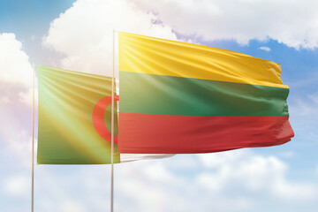 Sunny blue sky and flags of lithuania and algeria