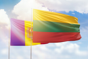 Sunny blue sky and flags of lithuania and andorra