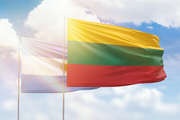 Sunny blue sky and flags of lithuania and argentina