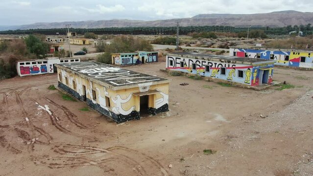 Abandoned barracks painted with graffiti,  Dead sea, drone view
Abandoned barracks of the Jordanian army during the Israeli - Arab conflict
