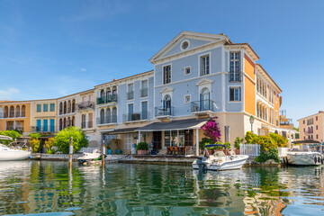 A group of waterfront homes with boat docks in the planned residential community of Port Grimaud,...