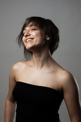 Fototapeta premium Beautiful girl upper body portrait. Smiling with wavy hair on face. .