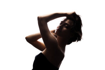 Half silhouette portrait of a girl with short hair and hands up. Isolated against white background. .