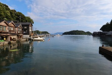 Fototapeta premium A scene of fishermen' s houses in the preserved area of them in Ine Town in Yosa-gun County in Kyoto Prefecture in Japan 日本の京都府与謝郡伊根町にある舟屋保存地区の舟屋の風景