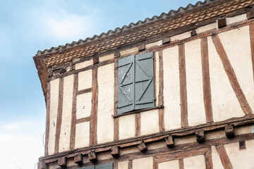 Obraz premium Facade of half timbered houses, medieval buildings, in a typical french medieval village and city, bergerac, in France, in Dordogne and Perigord, with a typical of the Southwestern French architecture