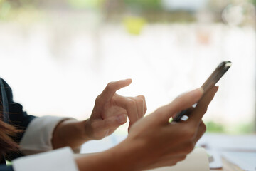 A businesswoman completes KYC using an online banking program in order to open a digital savings...