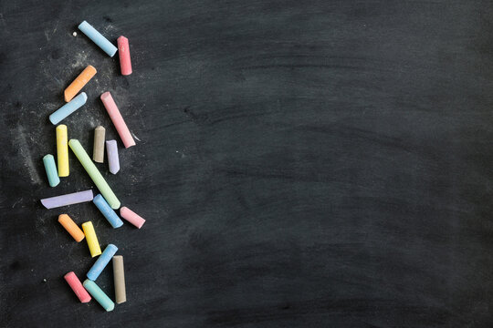Border of colourful chalk on a blackboard with copy space