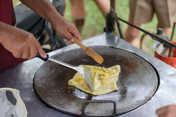 Top view of a man hand cooking vegetables martabak jawa in Kota Kinabalu City open market in Sabah...