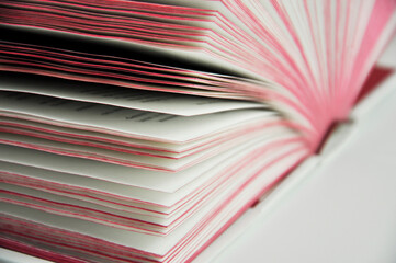 An open book on a white background. Blurred background.