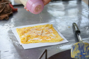 Roti Making, roti thresh flour by roti maker with oil. Indian traditional street food. Thai Pancake Banana And Egg . Thai Street Food and Desserts. Making of roti snack