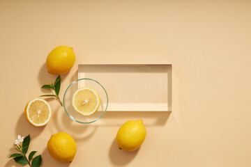 Top view of lemon decorated with transparent podium and green leaf blank space for advertising 