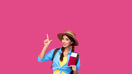 Woman passenger traveling abroad to travel on weekends getaway. Air flight journey concept. Holding passport ticket, point index finger up