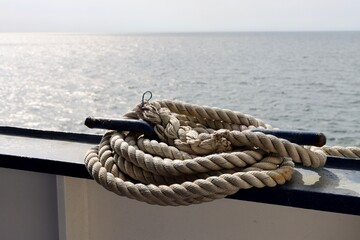 Fototapeta premium Coil of thick white rope aboard ship, close up