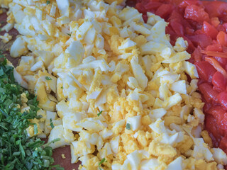 parsley, boiled egg and red bell pepper on kitchen board