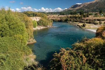 Fototapeta na wymiar The clear Hawea River flowing between Lake Hawea and Albert Town, Otago, South Island, New Zealand.