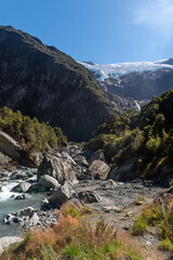 Fototapeta na wymiar Fast flowing Rob Roy Stream in the foreground with the Rob Roy Glacier in the background. Mount Aspiring National Park, Otago, South Island, New Zealand.