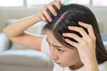 Damaged Hair, face serious asian young woman worry looking at scalp in mirror, hand in break into...