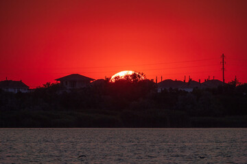 The sun goes down over a lake