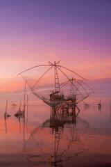 Fototapeta na wymiar The scenery of sunrise and sunset view with giant fishing traps in Southern of Thailand.