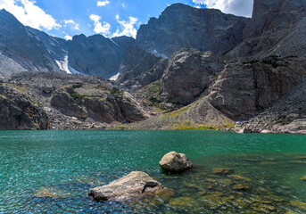 Sky Pond - A closeup view of a colorful alpine lake - Sky Pond at base of Taylor Peak and Taylor Glacier on a sunny Summer day. Rocky Mountain National Park, Colorado, USA.