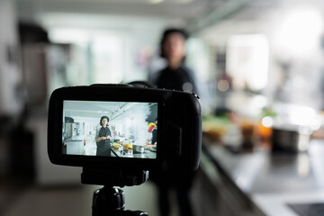 Close up of camera recording head cook presenting herbs and ingredients for dish while doing a...