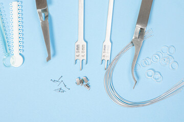 a set of special tools for an orthodontist to install braces for a patient. Orthodontic arcs, ligature, locks, positioner, tweezers