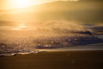 Fototapeta premium Sunrise background. Golden sunrise sunset over the sea waves. Sunrise over the ocean.