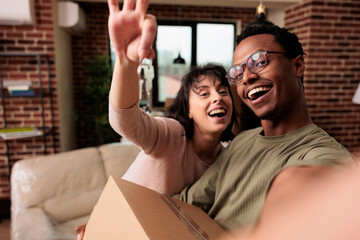 POV of happy homeowners holding house keys of rented flat, moving in new household property...