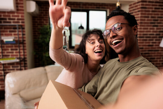 POV of happy homeowners holding house keys of rented flat, moving in new household property together to start family. Enjoying relocation and life event for new beginnings, real estate. - Powered by Adobe