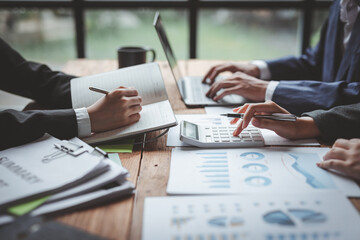 Business people advisors talk, planning analyze investment and marketing on a tablet in the office. Working with graph chart of business Report information.