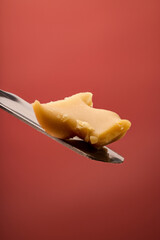 Fresh Rosin on a titanium dab tool with a burgundy background. 