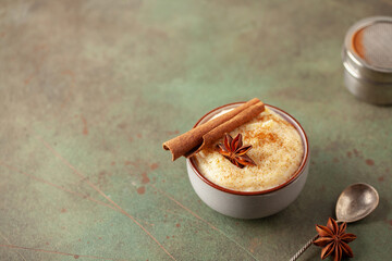 Curau de Milho (Brazilian Corn Pudding). Traditional Brazilian dessert. Corn porridge with cinnamon in a bowl.