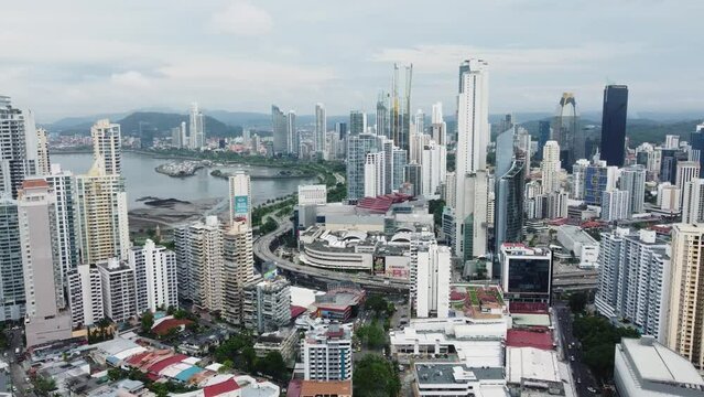 Panama city, Panama - May 30 2022: Traffic rushing on the Panamericana highway in the heart of Panama city downtown district facing the Pacific ocean in Central America. Shot with a forward motion. 