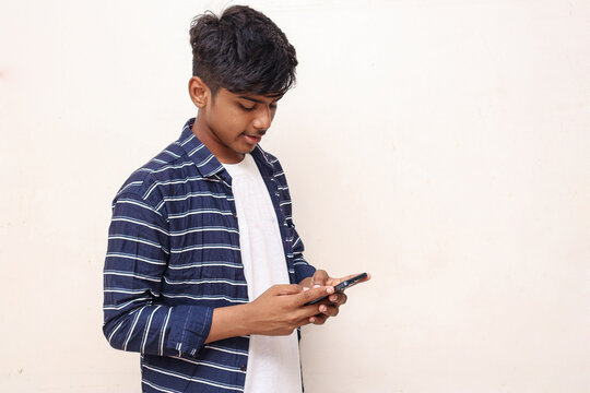 Indian College Student Using Smartphone On White Background.