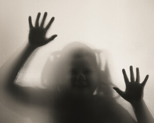 Shadowy figure, child behind glass - horror background